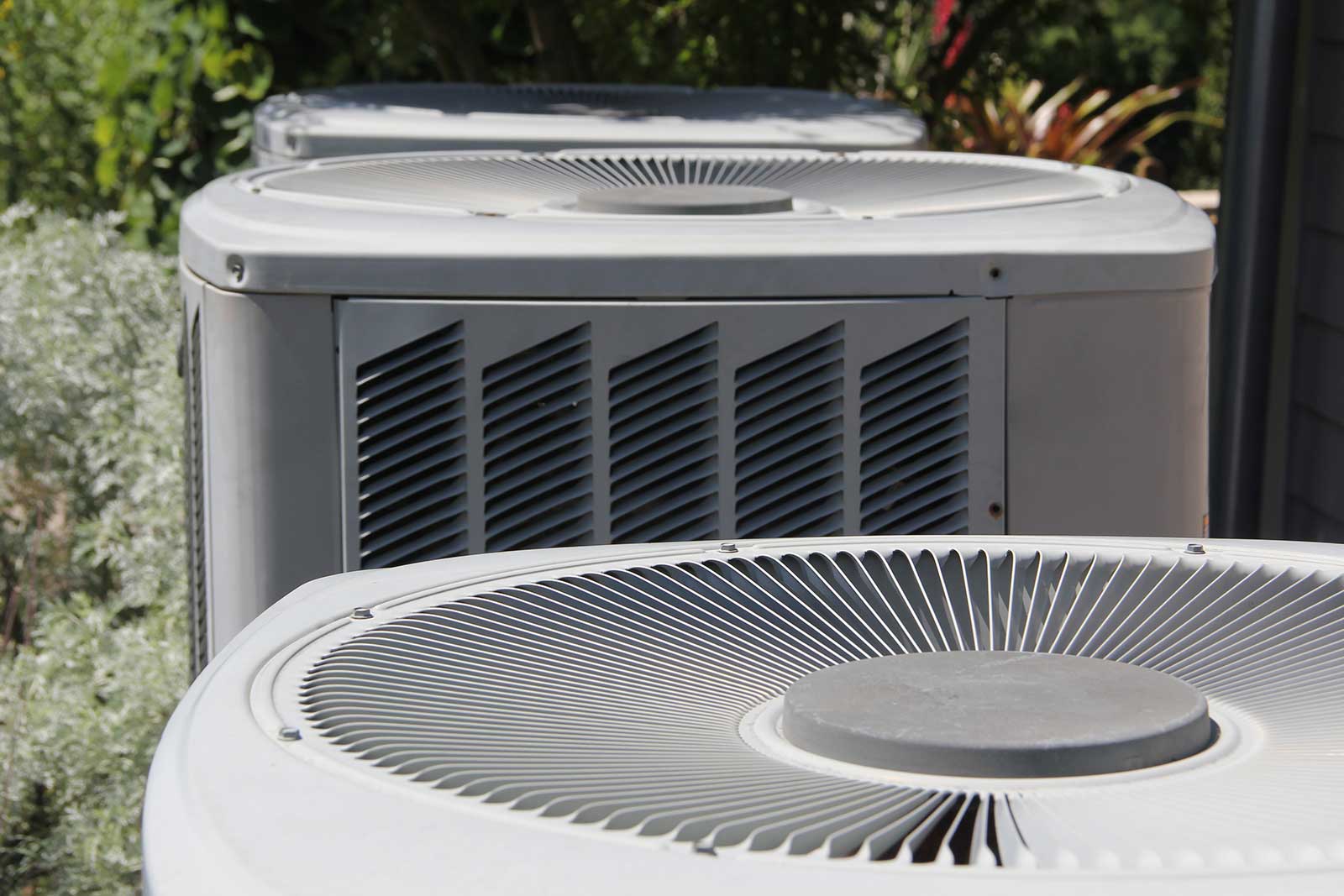 Residential HVAC units Residential HVAC condenser units installed beside a home