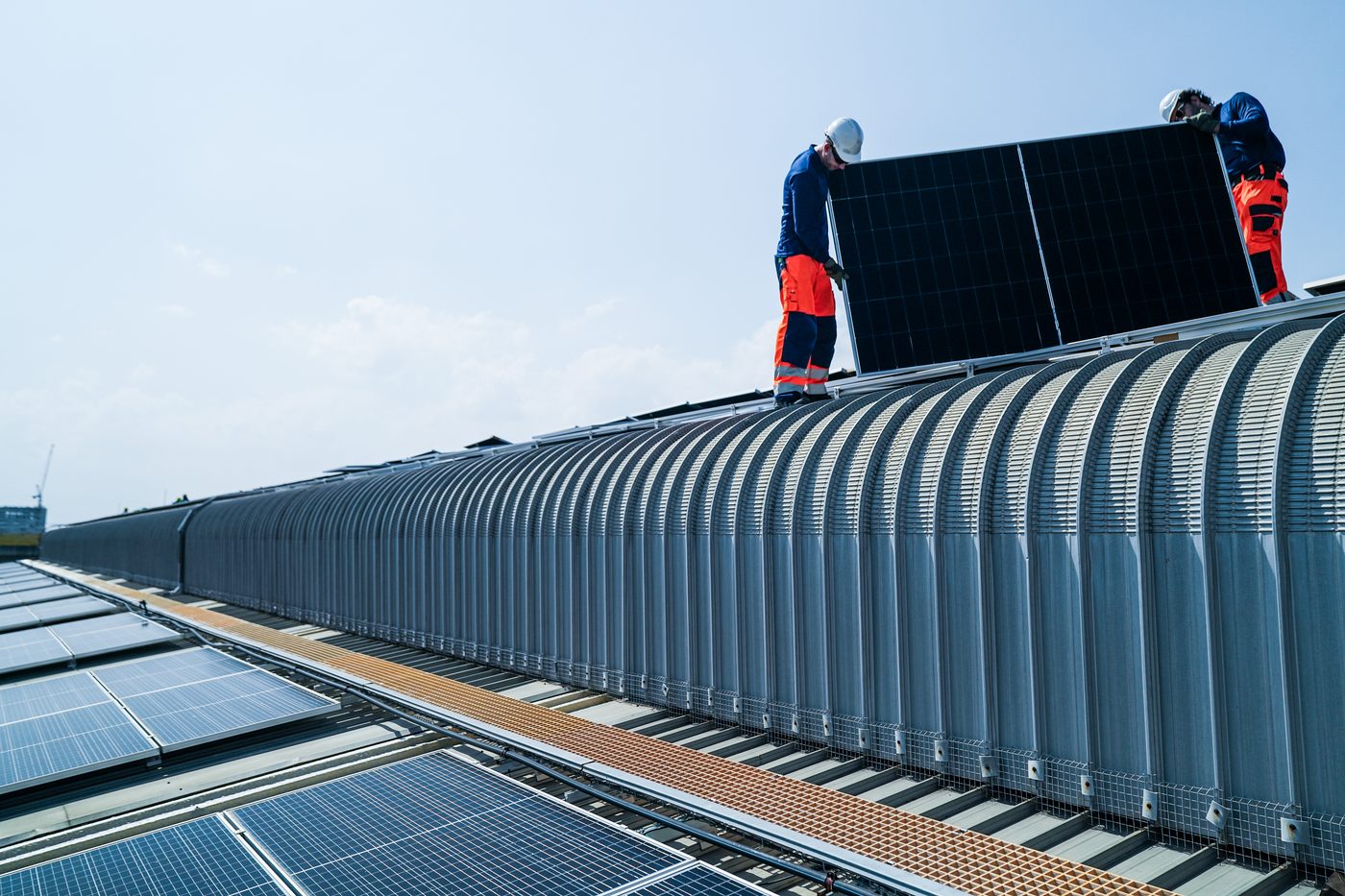 Build a smarter energy future Voltaic crew installing solar panels on a commercial rooftop