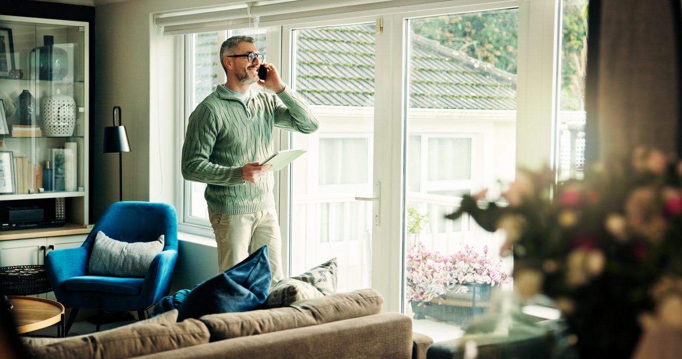 Verify a Voltaic representative Homeowner on the phone with a Voltaic representative in a bright living room
