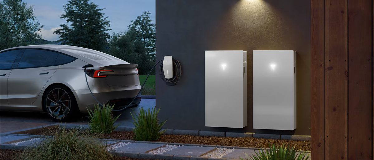 Battery storage with EV Two wall-mounted home batteries next to an EV charging at a home wall charger