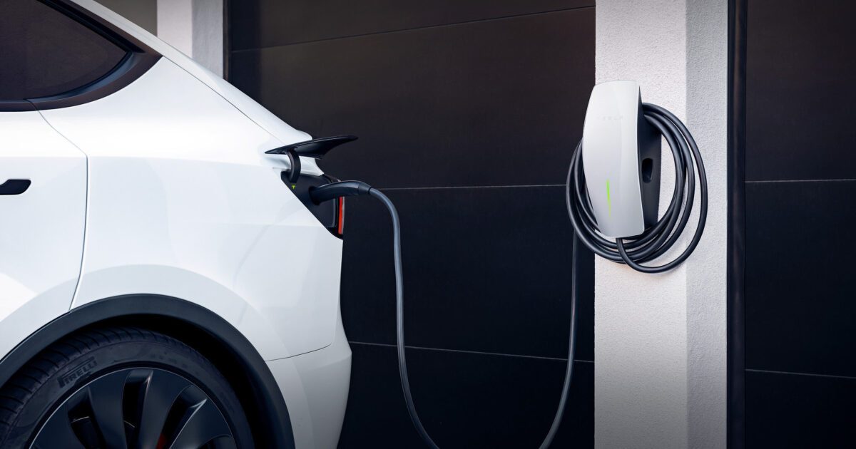 EV plugged into home charger Electric vehicle plugged into a home charging station